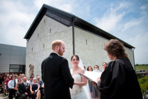 bride and groom getting married outside of museum