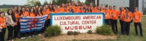 kids in orange t-shirts gathered around LACS sign