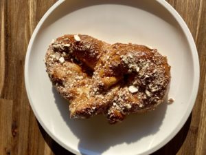 Bretzel with sugar and nuts on top.